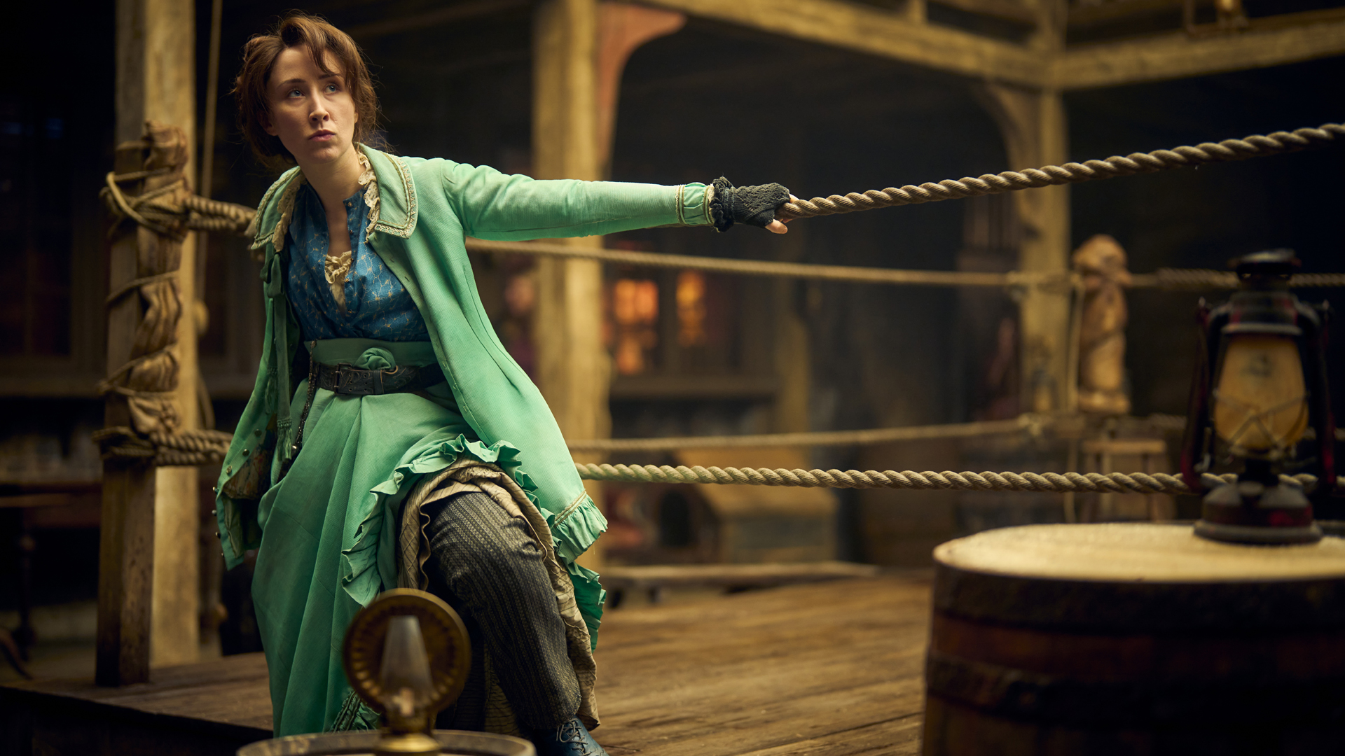 Mary Carr hangs off some ropes of a boxing ring in Disney's A Thousand Blows TV series