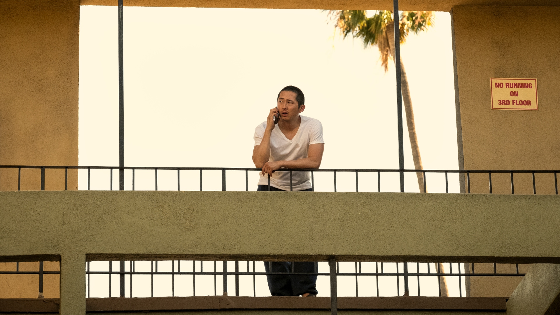 Danny stands on a balcony talking on the phone in Beef season 1