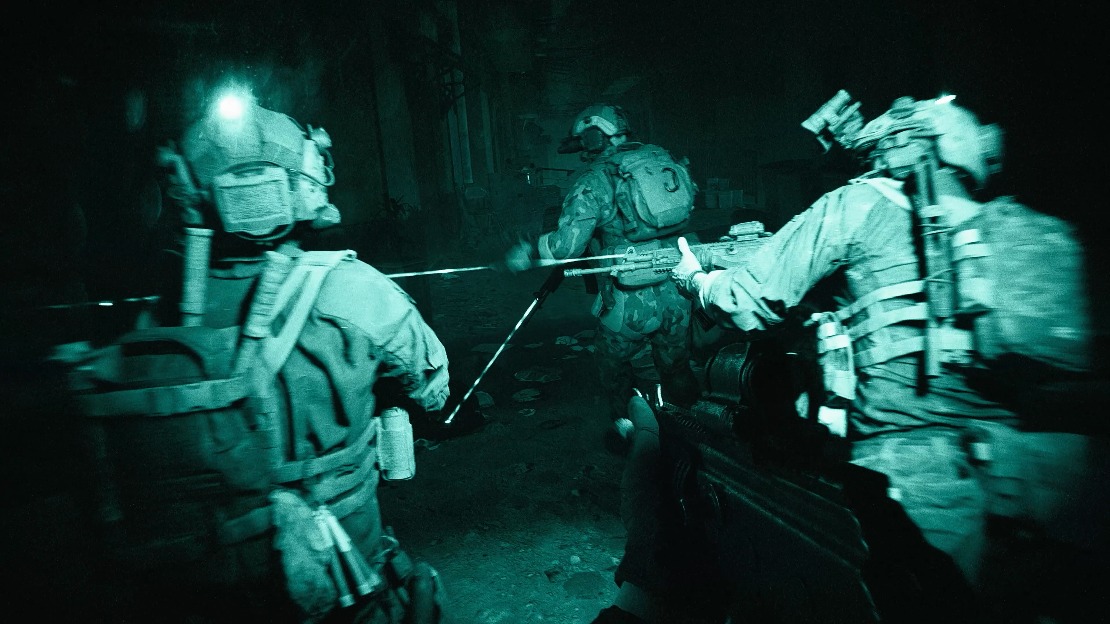 Soldiers move through a room in a night vision view