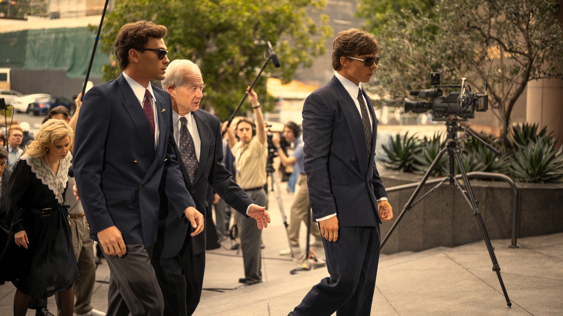 Lyke and Erik walk past the press