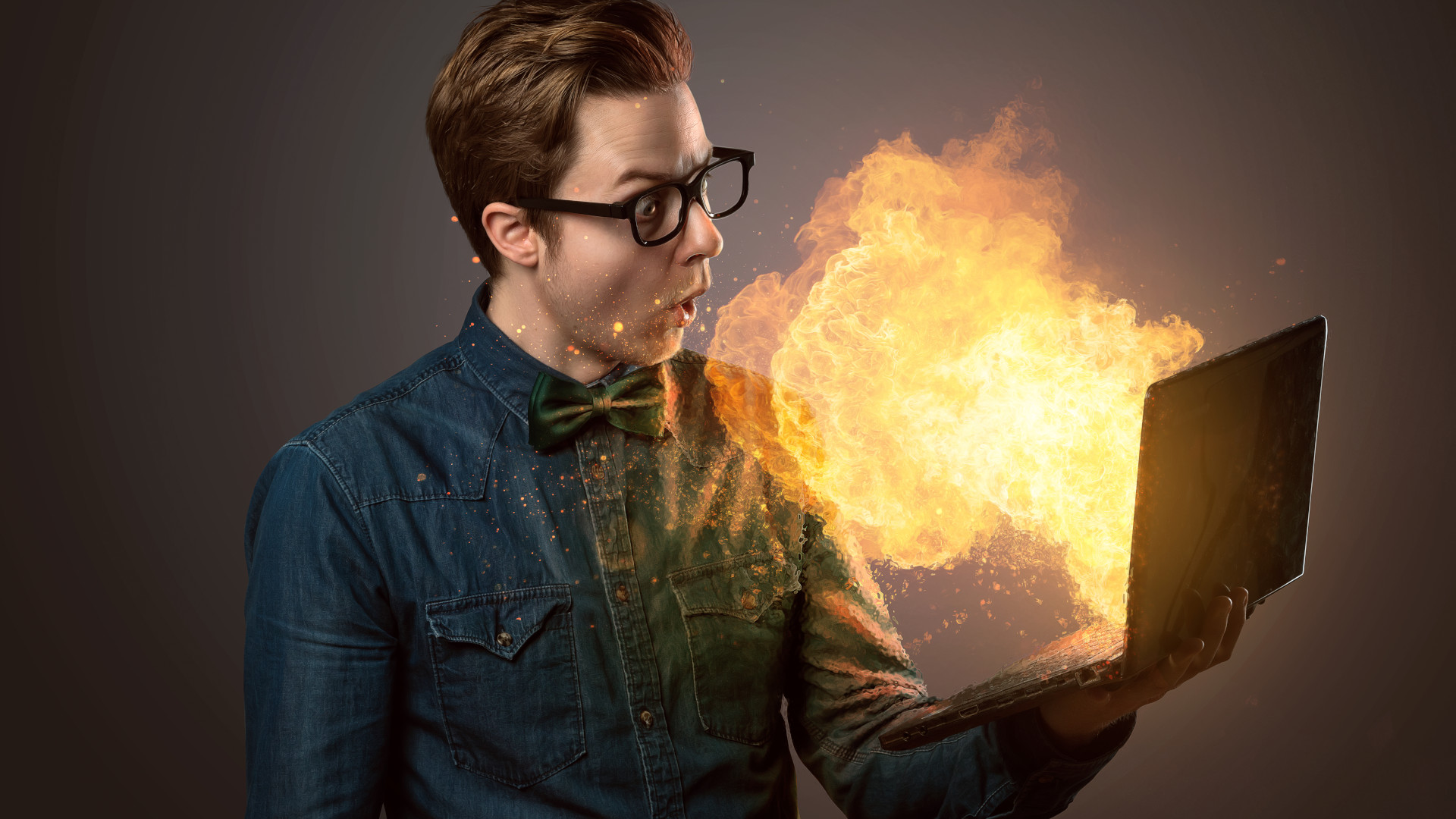 A laptop with fire coming out of the screen