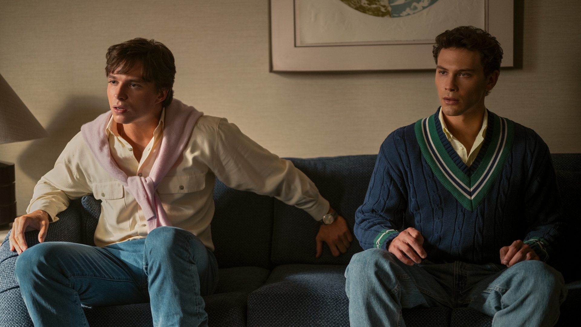 Erik and Lyle sit on a couch together