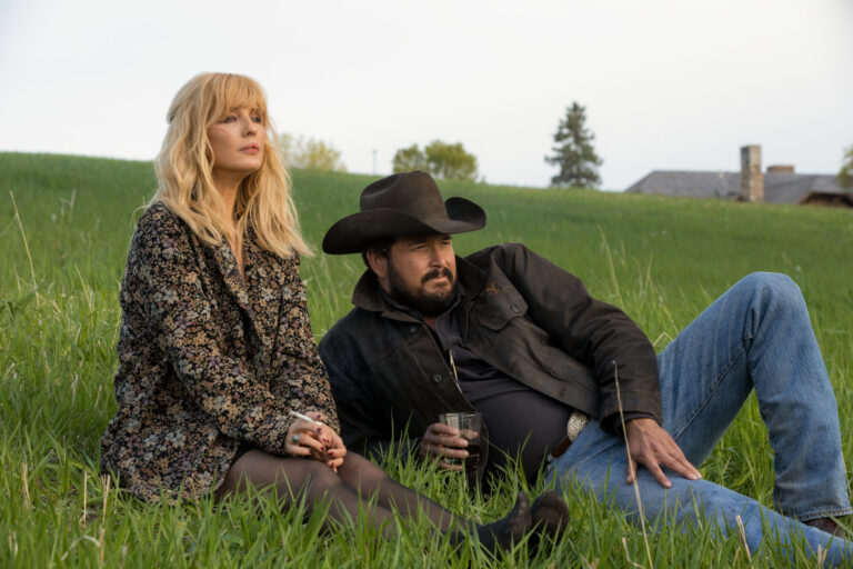 Beth Dutton and Rip Wheeler sitting on the grass