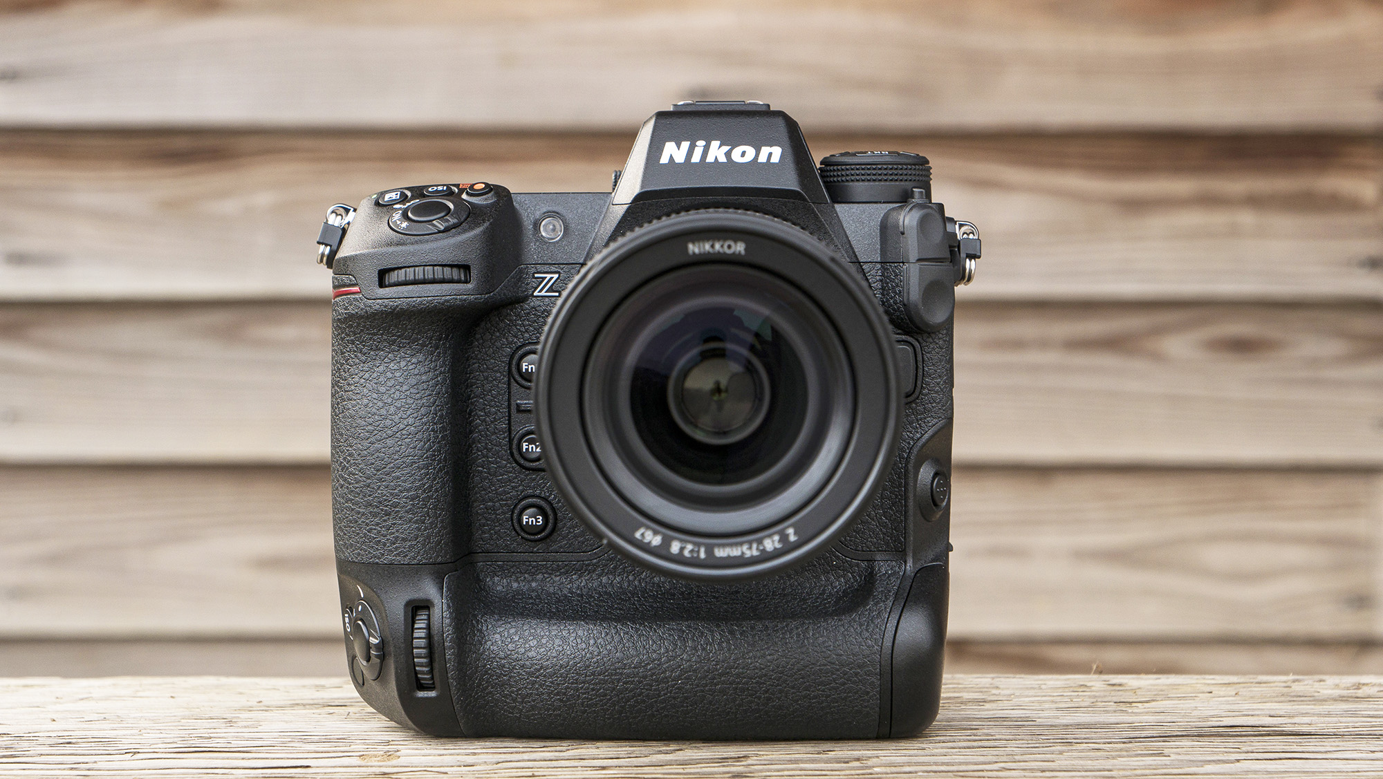Nikon Z9 on a bench in front of a wooden cabin