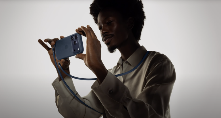 A man holding his iPhone.